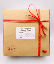 Load image into Gallery viewer, Handmade vegan soaps featuring a set of two sleeping cows . gift boxed in beautiful eco friendly packaging. crafted with natural French clays, activated charcoal and essential oils. a eco-friendly, zero waste gift that’s cruelty-free, skin-nourishing, the perfect gift for cow lovers and animal lovers. UK Small Business