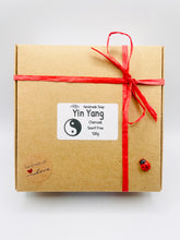 Load image into Gallery viewer, Handmade vegan soaps featuring a set of two yin and yang soaps, beautifully gift boxed in eco friendly packaging. crafted with natural French clays, activated charcoal and essential oils. a eco-friendly, zero waste gift that’s cruelty-free, skin-nourishing, and perfect for yoga lover gifts and gifts for her. Small business UK