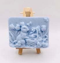 Load image into Gallery viewer, Handmade vegan soaps featuring the easter bunny with a basket full of chicks. , in beautiful eco friendly packaging. crafted with natural French clays, activated charcoal and essential oils. a eco-friendly, zero waste gift that’s cruelty-free, skin-nourishing, the perfect gift for easter and animal lovers. small business UK