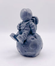 Load image into Gallery viewer, Handmade vegan soaps featuring a detailed astronaut / spaceman sitting on the moon. crafted with natural French clays, activated charcoal and essential oils. a eco-friendly, zero waste gift that’s cruelty-free, skin-nourishing, and perfect for space lover gifts. gifts for him. Wrapped in beautiful eco friendly packaging. Small Business UK