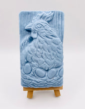 Load image into Gallery viewer, Handmade vegan soaps featuring a chicken sat on her nest of eggs, in beautiful eco friendly packaging. crafted with natural French clays, activated charcoal and essential oils. a eco-friendly, zero waste gift that’s cruelty-free, skin-nourishing, the perfect gift for easter and animal lovers. small business UK