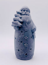 Load image into Gallery viewer, Christmas Gift UK. Handmade Father Christmas vegan soap in charcoal , detailed with a long beard, cosy hat, flowing robe with star cutouts, and holding a small Christmas tree over one shoulder and a lantern in the other hand. available in your own choice of coloured clays and essential oils. zero waste gift UK.