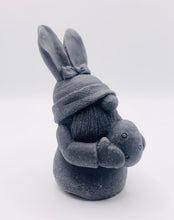 Load image into Gallery viewer, Handmade vegan soaps featuring a gorgeous gnome with easter bunny ears, holding his easter egg packaged in beautiful eco friendly packaging. crafted with natural French clays, activated charcoal and essential oils. a eco-friendly, zero waste gift thatās cruelty-free, skin-nourishing, the perfect gift for any easter hamper or gnome lover. UK Small Business