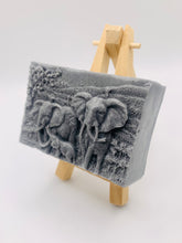 Load image into Gallery viewer, Elephant Gift | unique elephant Gift. Zro waste gift. Modern gift ideas. Etsy Uk. Handmade home style. How beautiful is this Elephant Family soap? Featuring Mum, Dad, and Baby Elephant, each bar is exquisitely detailed, capturing the gentle spirit of these majestic animals.
Our soap is vegan, cruelty-free, and made with natural French clays and luxurious essential oils, offering a rich, soothing cleanse for your skin. The earthy tones and soft scents will transport you to nature, making bath time a serene