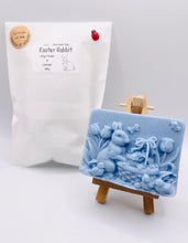 Load image into Gallery viewer, Handmade vegan soaps featuring the easter bunny with a basket full of chicks. , in beautiful eco friendly packaging. crafted with natural French clays, activated charcoal and essential oils. a eco-friendly, zero waste gift that’s cruelty-free, skin-nourishing, the perfect gift for easter and animal lovers. small business UK