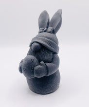 Load image into Gallery viewer, Handmade vegan soaps featuring a gorgeous gnome with easter bunny ears, holding his easter egg packaged in beautiful eco friendly packaging. crafted with natural French clays, activated charcoal and essential oils. a eco-friendly, zero waste gift thatās cruelty-free, skin-nourishing, the perfect gift for any easter hamper or gnome lover. UK Small Business