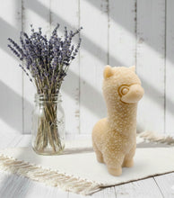 Load image into Gallery viewer, highly detailed handmade vegan soap in the shape of a cute alpaca or llama with a textured woolly finish, displayed against a whimsical farmhouse decor background