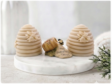 Load image into Gallery viewer, Two handmade vegan soaps sculpted into traditional dome-shaped beehives (skeps) with small bees resting on the sides, flanking a decorative centrepiece featuring a honey pot and the words "The Sweetest Thing," all displayed on a rustic wooden surface.