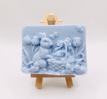 Load image into Gallery viewer, Handmade vegan soaps featuring the easter bunny with a basket full of chicks. , in beautiful eco friendly packaging. crafted with natural French clays, activated charcoal and essential oils. a eco-friendly, zero waste gift that’s cruelty-free, skin-nourishing, the perfect gift for easter and animal lovers. small business UK