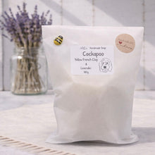 Load image into Gallery viewer, Bag of Cockapoo Yellow French Clay & Lavender soap with a jar of lavender flowers in the background.