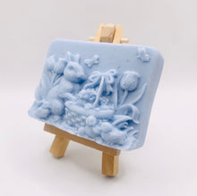 Load image into Gallery viewer, Handmade vegan soaps featuring the easter bunny with a basket full of chicks. , in beautiful eco friendly packaging. crafted with natural French clays, activated charcoal and essential oils. a eco-friendly, zero waste gift that’s cruelty-free, skin-nourishing, the perfect gift for easter and animal lovers. small business UK