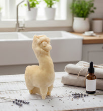 Load image into Gallery viewer, Soap bar shaped like an alpaca or llama on a kitchen counter with towels and a bottle of oil.