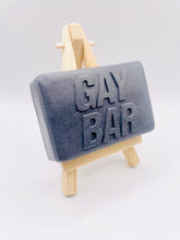 Load image into Gallery viewer, Handmade vegan soaps featuring the wording GAY BAR novelty gift. crafted with natural French clays, activated charcoal and essential oils. a eco-friendly, zero waste gift that’s cruelty-free, skin-nourishing, and perfect for pride gifts and LGBTQ gifts, hen party favours. wrapped in beautiful eco friendly packaging.