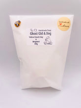 Load image into Gallery viewer, Handmade vegan soaps shaped as a cute ghost girl walking a dog. crafted with natural French clays, activated charcoal and essential oils. a eco-friendly, zero waste gift that’s cruelty-free, skin-nourishing, and perfect for Halloween and gifting. Small business UK.