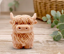 Load image into Gallery viewer, Large handmade vegan soap in the shape of a fluffy Highland cow calf with a detailed, shaggy coat, displayed against a whimsical farmhouse decor background.