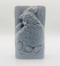 Load image into Gallery viewer, Handmade vegan soaps featuring a chicken sat on her nest of eggs, in beautiful eco friendly packaging. crafted with natural French clays, activated charcoal and essential oils. a eco-friendly, zero waste gift that’s cruelty-free, skin-nourishing, the perfect gift for easter and animal lovers. small business UK