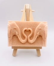 Load image into Gallery viewer, Handmade vegan soaps featuring two elephants who's trunks meet in a heart shape packed in beautiful eco friendly packaging. crafted with natural French clays, activated charcoal and essential oils. a eco-friendly, zero waste gift thatās cruelty-free, skin-nourishing, and perfect for elephant lovers or animal themed gifts. Small business UK