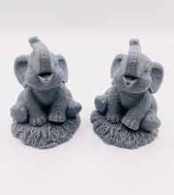 Load image into Gallery viewer, Handmade vegan soaps featuring a set of two baby elephants, gift boxed in beautiful eco friendly packaging. crafted with natural French clays, activated charcoal and essential oils. a eco-friendly, zero waste gift that’s cruelty-free, skin-nourishing, the perfect gift for elephant lovers or for animal lovers. small business UK