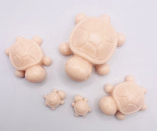 Load image into Gallery viewer, Handmade vegan soaps featuring a set of 5 turtle family soaps and gift boxed in beautiful eco friendly packaging crafted with natural French clays, activated charcoal and essential oils. a eco-friendly, zero waste gift that’s cruelty-free, skin-nourishing, and perfect for turtle lovers and animal themed gifts. small business UK