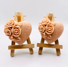 Load image into Gallery viewer, Handmade vegan soaps featuring a set of two love heart soaps with wording I LOVE U with flowers, gift boxed in beautiful eco friendly packaging. crafted with natural French clays, activated charcoal and essential oils. a eco-friendly, zero waste gift that’s cruelty-free, skin-nourishing, and perfect for romantic valentines gifts and anniversary gifts. small business UK