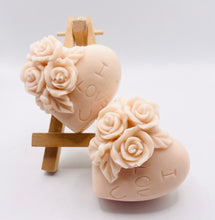 Load image into Gallery viewer, Handmade vegan soaps featuring a set of two love heart soaps with wording I LOVE U with flowers, gift boxed in beautiful eco friendly packaging. crafted with natural French clays, activated charcoal and essential oils. a eco-friendly, zero waste gift that’s cruelty-free, skin-nourishing, and perfect for romantic valentines gifts and anniversary gifts. small business UK