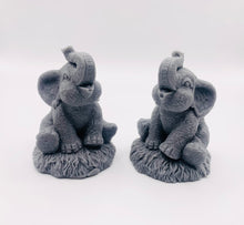 Load image into Gallery viewer, Handmade vegan soaps featuring a set of two baby elephants, gift boxed in beautiful eco friendly packaging. crafted with natural French clays, activated charcoal and essential oils. a eco-friendly, zero waste gift that’s cruelty-free, skin-nourishing, the perfect gift for elephant lovers or for animal lovers. small business UK