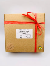 Load image into Gallery viewer, Handmade vegan soaps featuring a set of three cute laughing pigs, gift boxed in beautiful eco friendly packaging. crafted with natural French clays, activated charcoal and essential oils. a eco-friendly, zero waste gift thatās cruelty-free, skin-nourishing, and perfect for animal lovers, pig lovers and teacher appreciation gifts. small business UK