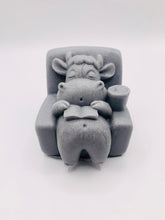 Load image into Gallery viewer, Handmade vegan cow sleeping on the sofa with book and coffee, shaped vegan soaps. crafted with natural French clays, activated charcoal and essential oils. a eco-friendly, zero waste gift that’s cruelty-free, skin-nourishing, and perfect for animal lovers and gifting. small business UK