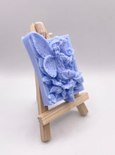 Load image into Gallery viewer, Handmade vegan soaps featuring a fairy sitting on leaves and holding a flower in beautiful eco friendly packaging. crafted with natural French clays, activated charcoal and essential oils. a eco-friendly, zero waste gift that’s cruelty-free, skin-nourishing, the perfect gift for fairy lovers or mothers day. small business UK