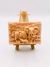 Load image into Gallery viewer, Handmade vegan soap featuring an elephant family with baby elephant and packed in beautiful eco friendly packaging. crafted with natural French clays, activated charcoal and essential oils. a eco-friendly, zero waste gift that’s cruelty-free, skin-nourishing, and perfect for elephant lovers or animal themed gifts. Small business UK