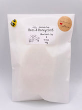 Load image into Gallery viewer, Handmade vegan soaps featuring two bees on honeycomb wrapped in beautiful eco friendly packaging crafted with natural French clays, activated charcoal and essential oils. a eco-friendly, zero waste gift that’s cruelty-free, skin-nourishing, and perfect gift for bee lovers and animal themed gifts. small business UK