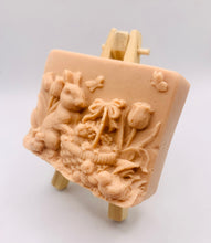 Load image into Gallery viewer, Handmade vegan soaps featuring the easter bunny with a basket full of chicks. , in beautiful eco friendly packaging. crafted with natural French clays, activated charcoal and essential oils. a eco-friendly, zero waste gift that’s cruelty-free, skin-nourishing, the perfect gift for easter and animal lovers. small business UK