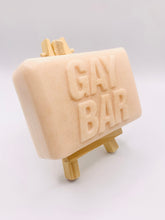 Load image into Gallery viewer, Handmade vegan soap featuring the writing GAY BAR and packaged in beautiful eco friendly packaging. crafted with natural French clays, activated charcoal and essential oils. a eco-friendly, zero waste gift that’s cruelty-free, skin-nourishing, and perfect for pride Gifts and novelty themed gifts. Small business UK