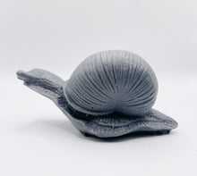 Load image into Gallery viewer, Handmade vegan soaps featuring a detailed snail, in beautiful eco friendly packaging. crafted with natural French clays, activated charcoal and essential oils. a eco-friendly, zero waste gift that’s cruelty-free, skin-nourishing, the perfect gift for snail lovers, gardeners or for animal lovers. small business UK