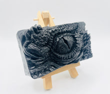 Load image into Gallery viewer, dragon Gift | dragon eye gift, dino gift, alternative gift, Dragon / Dinosaur Eye Vegan Soap Wooden display easels are available to purchase on a separate listing Calling all fantasy lovers! Step into a realm of mystical charm with our captivating dragon / dinosaur eye soap. This soap is vegan, cruelty free and available in your choice of colour and essential oil. All our soaps are made with natural clays and essential oils to gently cleanse and nourish your skin. eco conscious gift