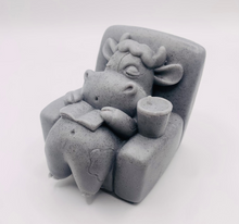 Load image into Gallery viewer, Handmade vegan cow sleeping on the sofa with book and coffee, shaped vegan soaps. crafted with natural French clays, activated charcoal and essential oils. a eco-friendly, zero waste gift that’s cruelty-free, skin-nourishing, and perfect for animal lovers and gifting. small business UK