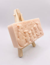 Load image into Gallery viewer, dog lover gift. cat lover gift. animal lover gift. zero waste gift. modern gifts. handmade home style. This beautifully detailed, chunky bar features a line-up of our loyal four-legged friends, reminding us of the love, joy, and muddy footprints they bring into our lives. The one in the photo is made with charcoal and lavender essential oil, soothing, earthy, and perfect for washing the day away (or after a long dog walk!). eco conscious home. eco conscious living.