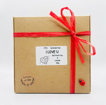Load image into Gallery viewer, Handmade vegan soaps featuring a set of two love heart soaps with wording I LOVE U with flowers, gift boxed in beautiful eco friendly packaging. crafted with natural French clays, activated charcoal and essential oils. a eco-friendly, zero waste gift that’s cruelty-free, skin-nourishing, and perfect for romantic valentines gifts and anniversary gifts. small business UK