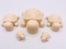 Load image into Gallery viewer, Handmade vegan soaps featuring a set of 5 turtle family soaps and gift boxed in beautiful eco friendly packaging crafted with natural French clays, activated charcoal and essential oils. a eco-friendly, zero waste gift that’s cruelty-free, skin-nourishing, and perfect for turtle lovers and animal themed gifts. small business UK