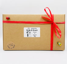 Load image into Gallery viewer, Handmade vegan soaps featuring a charcoal groom soap and a detailed bride soap. gift boxed in beautiful eco friendly packaging. crafted with natural French clays, activated charcoal and essential oils. a eco-friendly, zero waste gift that’s cruelty-free, skin-nourishing, the perfect gift for any wedding. UK Small Business