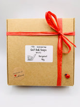 Load image into Gallery viewer, Handmade vegan soaps shaped as two golf balls, gift boxed in beautiful eco friendly packaging. crafted with natural French clays, activated charcoal and essential oils. a eco-friendly, zero waste gift that’s cruelty-free, skin-nourishing, and perfect for golf lovers and gifting . Small business UK