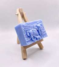 Load image into Gallery viewer, Handmade vegan soap featuring an elephant family with baby elephant and packed in beautiful eco friendly packaging. crafted with natural French clays, activated charcoal and essential oils. a eco-friendly, zero waste gift that’s cruelty-free, skin-nourishing, and perfect for elephant lovers or animal themed gifts. Small business UK
