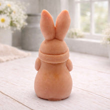 Load image into Gallery viewer, A detailed handmade vegan soap in a natural colour, sculpted as a whimsical Easter gnome (gonk) with long rabbit ears and a bow on its hat, holding a patterned Easter egg, displayed on a light wooden surface. Easter gift