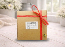 Load image into Gallery viewer, Gift box with a red ribbon on a wooden surface with a blurred background