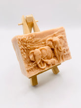 Load image into Gallery viewer, Handmade vegan soap featuring an elephant family with baby elephant and packed in beautiful eco friendly packaging. crafted with natural French clays, activated charcoal and essential oils. a eco-friendly, zero waste gift that’s cruelty-free, skin-nourishing, and perfect for elephant lovers or animal themed gifts. Small business UK