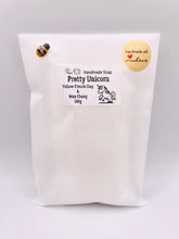 Load image into Gallery viewer, Handmade vegan soaps featuring a unicorn head and wrapped in beautiful eco friendly packaging crafted with natural French clays, activated charcoal and essential oils. a eco-friendly, zero waste gift that’s cruelty-free, skin-nourishing, and perfect gift for unicorn lovers. small business UK