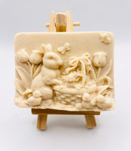 Load image into Gallery viewer, Handmade vegan soaps featuring the easter bunny with a basket full of chicks. , in beautiful eco friendly packaging. crafted with natural French clays, activated charcoal and essential oils. a eco-friendly, zero waste gift that’s cruelty-free, skin-nourishing, the perfect gift for easter and animal lovers. small business UK