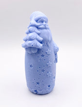 Load image into Gallery viewer, Christmas Gift UK. Handmade Father Christmas vegan soap in indigo blue, detailed with a long beard, cosy hat, flowing robe with star cutouts, and holding a small Christmas tree over one shoulder and a lantern in the other hand. available in your own choice of coloured clays and essential oils. zero waste gift UK.