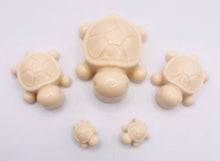 Load image into Gallery viewer, Handmade vegan soaps featuring a set of 5 turtle family soaps and gift boxed in beautiful eco friendly packaging crafted with natural French clays, activated charcoal and essential oils. a eco-friendly, zero waste gift that’s cruelty-free, skin-nourishing, and perfect for turtle lovers and animal themed gifts. small business UK