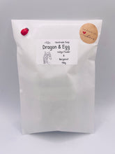 Load image into Gallery viewer, Dinosaur Gift | dinosaur Lover Gift | dragon Lover Gift | alternative Gift | Dragon & Egg Vegan Soap Check out this majestic dragon guarding a mysterious, enchanting egg – all captured in a luxurious bar of soap! Vegan, cruelty-free, and elegantly wrapped in eco-friendly packaging. All our soaps are made with natural clays and essential oils to gently cleanse and nourish your skin. Plus, they come in eco-friendly packaging so you can feel good about your purchase and the environment.